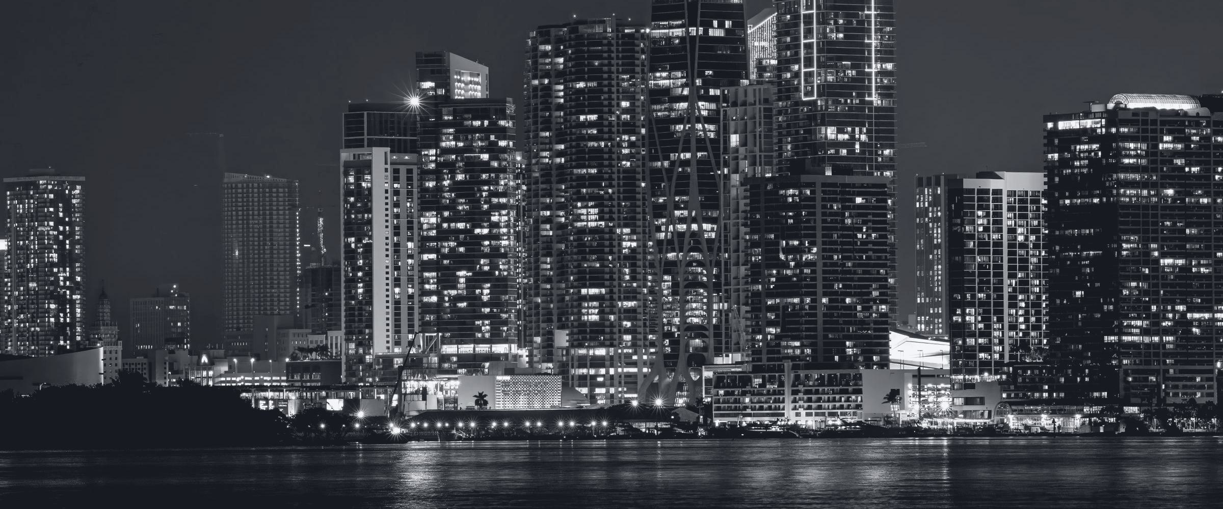The downtown Miami skyline at night, seen across Biscayne Bay.